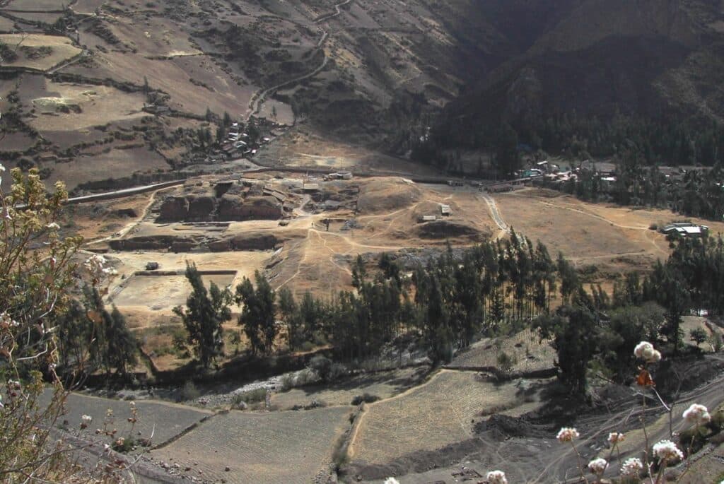 aerial view of the site of Chavin de Huantar in modern-day Peru, which hosts several monumental buildings overseeing a large plaza, located at an elevation of 10,000 ft.